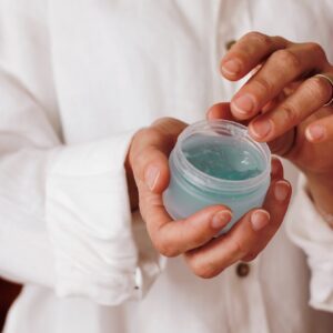 person holding blue plastic container